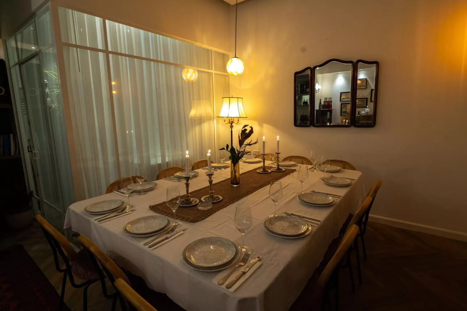 שולחן ערוך לאירוע ערב בבית השף עם תאורה חמימה ונרות